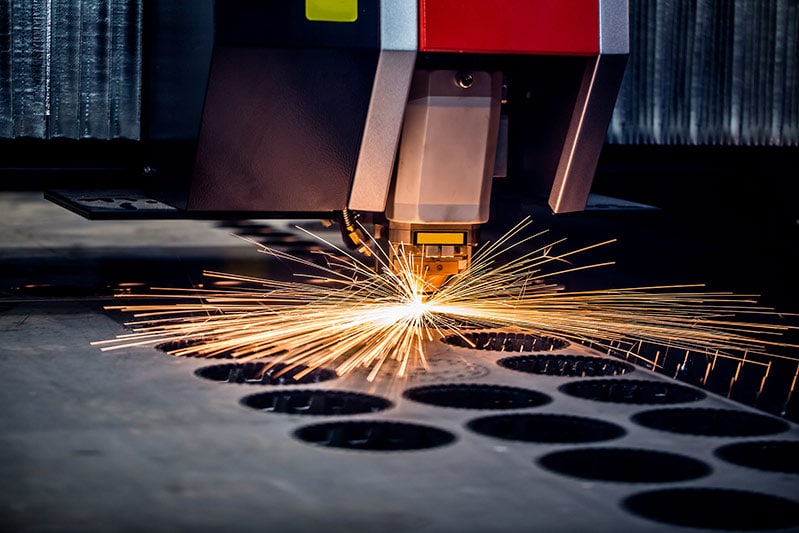 laser cutting metal with sparks flying